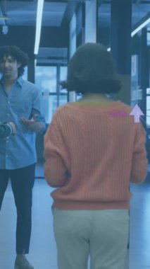 Animation of network of connections with icons over diverse business people working at office. Global business and digital interface concept digitally generated video.