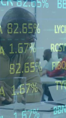 Animation of financial data processing over diverse business people. Global business, finances, computing and data processing concept digitally generated video.