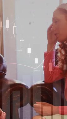 Animation of data processing over caucasian businesswomen talking in office. Global business and digital interface concept digitally generated video.