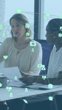 Bağlı ikonların dünyayı oluşturması, çeşitli kadın iş arkadaşlarının dizüstü bilgisayarlarda raporları tartışması. Dijital bileşik, çoklu pozlama, küreselleşme, iletişim, takım çalışması, teknoloji, iş.