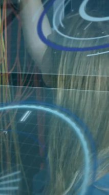 Animation of interface with data processing over caucasian female engineer working at server room. Computer interface and business data storage technology concept