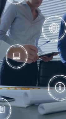 Animation of icons and data processing over diverse business people in office. Global business, finances, computing and data processing concept digitally generated video.