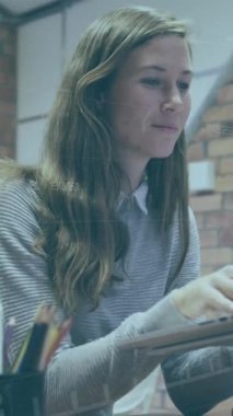 Animation of data processing over caucasian business people working in office. Global business and digital interface concept digitally generated video.