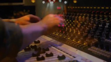 Müzik stüdyosundaki ses mühendisi konsol faders, animasyon seviyesinin yükseldiğini gösteriyor. Profesyonel, teknoloji, minimalist, müzik, ses, kontrol, ekipman