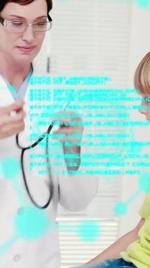 Medical data processing against caucasian female doctor treating a caucasian boy at hospital. medical research and science technology concept