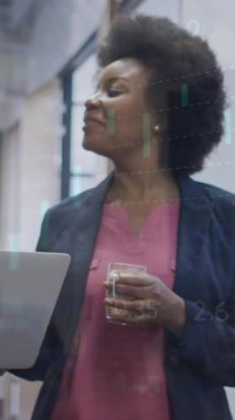 Animation of financial data processing over diverse businesswomen in office. Global business, finance, computing and data processing concept digitally generated video.