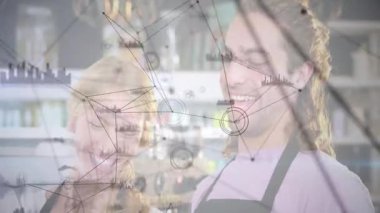 Mutfaktaki tablete bakan ve besin teknolojisi grafiklerine dönüşen düğümleri etkinleştiren çift. İşbirliği, yenilik, teknoloji, veri görselleştirme, modern, katılım, takım çalışması