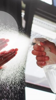 Animation of light spots over diverse people disinfecting hands. Protection, virus, healthcare and lifestyle concept digitally generated video.