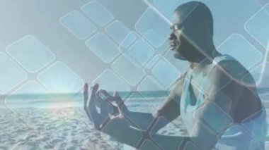 Sağlık koçu, meditasyon sırasında eriyen gündoğumunu aktifleştiren karelere bakıyor. Farkındalık, sükunet, sahil, dinginlik, elektronik, aydınlanma, bütünsellik,