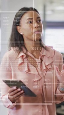 Animation of financial data processing over diverse business people in office. Global business, finances, computing and data processing concept digitally generated video.