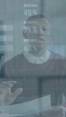 Animation of financial data processing over african american businessman having video call at office. Global business, finances and digital interface concept, digitally generated video.