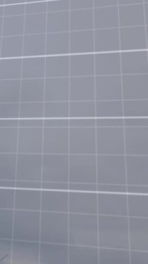 Animation of financial data processing over spinning windmills against grey sky. Global finance and renewable energy technology concept