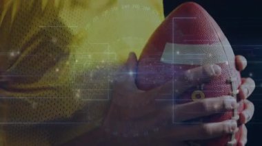 Sporcu topu sıkıca kavrıyor ve kaskı eğiyor. Kamera da spor teknolojisi verileriyle geri çekiliyor. Spor, teknoloji, yenilik, performans, analitik, fitness, görselleştirme