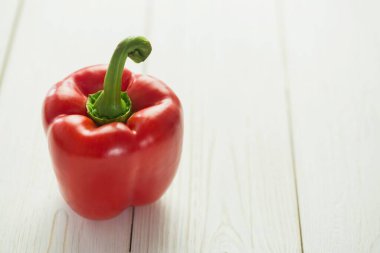 Close-up of fresh red pepper on wooden table