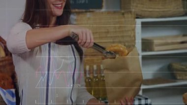 Pastane tezgâhtarı maşalı simit seçiyor ve grafikler azalırken satışları izlemek için poşete koyuyor. Fırın, pasta, ekmek, zanaatkar, ticari, perakende, konforlu