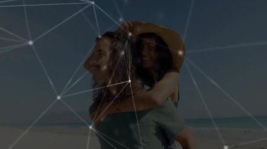 Adam kumlu plajda kadını sırtında taşırken dijital ağ teknoloji demosunda sürükleniyordu. Aşk, eğlence, macera, bağlantı, dinginlik, canlılık, dijital