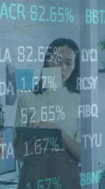 Animation of trading board, infographic interface, diverse coworkers sharing ideas on digital tablet. Digital composite, multiple exposure, stock market, business, teamwork, communication, technology.