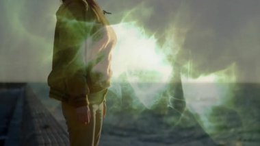 Sağlık arayıcısı iskelede duruyor gün batımında okyanus ufkunda beliren yeşil sis aracılığıyla enerjiyi algılıyor. Mistik, dinginlik, gençleşme, doğa, maneviyat, atmosfer, soyut