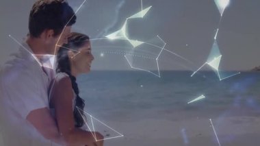 Küresel ağ verilerini araştıran bir çift, kumsal kadınına dünyayı oluşturan düğümleri seyrediyor. Romantik, bağlantı, holografi, yenilik, keşif, dinginlik, teknoloji