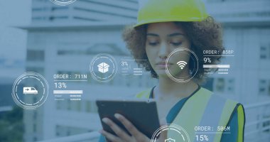 Reviewing engineer reading tablet on building site, with yellow safety helmet, reflective vest. Construction, technology, safety, urban, progress, management, industrial