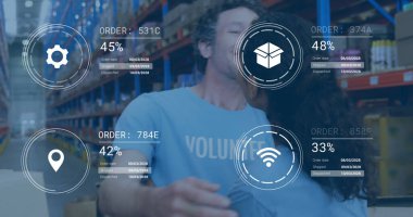 Two volunteers wearing light blue shirts hugging in warehouse with boxes and digital overlays. Collaboration, teamwork, logistics, inventory, communication, organization, efficiency