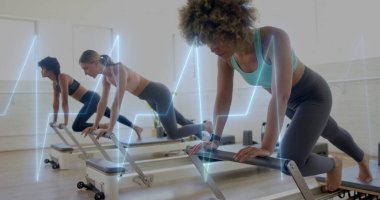 Holding plank sportswear-clad woman on reformer at Pilates studio, fitness tracker, copy space. Fitness, wellness, flexibility, strength, exercise, movement, interior