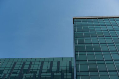 Low angle view of office building against blue sky