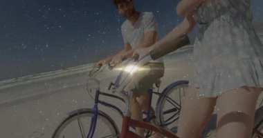 Sahil şeridi boyunca pedal çeviren, sohbet eden ve seyahat reklamında okyanusa bakan çift. Romantik, boş zaman, macera, mahsul, manzara, rahatlama, yaz zamanı