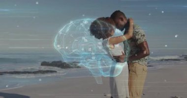 Gün batımında kumsalda kucaklaşan çift, üç boyutlu beyin ortaya çıkıyor ve teknoloji zihin bağlantısını gösteriyor. Romantizm, samimiyet, bağlantı, uyum, dinginlik, ruh hali, arkadaşlık.