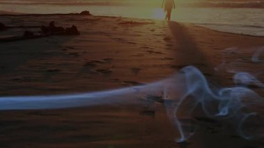 Alacakaranlık kıyısında süzülen perileri gösteren bir seyahat reklamı. Önde gelen yürüyüşçüler ayak etrafında dönen dumanı takip ediyor. Mistik, manevi, manzara, dinginlik, siluet, sükunet, doğa