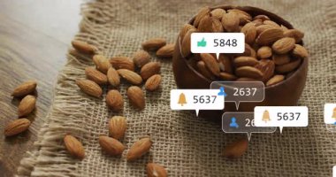 Badem kâsesinin üzerinde sosyal medya simgeleri beliriyor istatistikler dalgalanıyor ve nişan gösteriyor. Rustik, minimalizm, doğal, bağlılık, popülerlik, organik, etkileşim