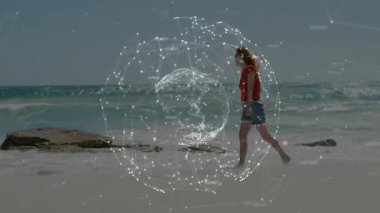 Teknoloji küresi ortaya çıkıyor ve kadın sahilde yürüyor dönen ağ üzerinden kumsal gezintisi. Fütürist, minimalist, dijital, bağlantı, keşif, huzur, doğal