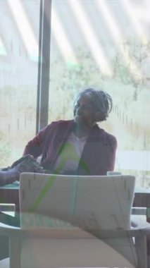 Animation of financial data processing over diverse business people in office. Global business, finances, computing and data processing concept digitally generated video.