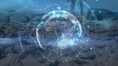 Dünya hologramı teknolojik planlama için karda görünürken, kadın kayak takımının önünde diz çöküyor. Gelecek, kış, keşif, dijital, yenilik, macera, teknoloji