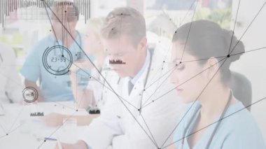 Hospital team collaborating on clinical case, nurse flipping report page causing data overlays. Medical, teamwork, collaboration, professional, modern, healthcare, discussion