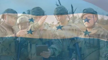 Military squad assembling on field starting route planning tapping tablet outlining animated path. Combat, teamwork, strategy, reconnaissance, tactical, outdoor, technology