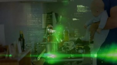 Yeşil kaplama, babayı karıştırıyor, spatula eğiliyor, elinde bebek izleme cihazı var. Ebeveynlik, teknoloji, aşçılık, yenilik, aile, dijital, ev