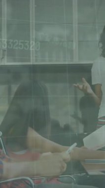 Animation of data processing over diverse business people working in office. Global business, finances, computing and data processing concept digitally generated video.