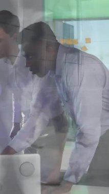 Animation of data processing over diverse business people using laptop. Global business digital interface technology and networking concept digitally generated video.