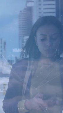 Animation of network of connections against african american businesswoman using smartphone. Global networking and business technology concept