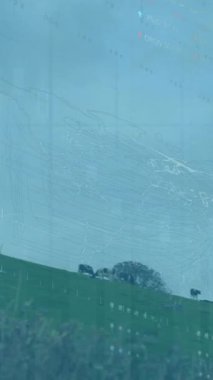 Animation of financial data processing over wind turbine. Global sustainability, wind energy, business, finances, computing and data processing concept digitally generated video.