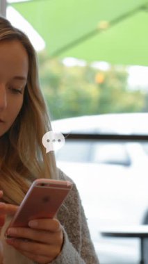 Animation of social media icons over caucasian woman using smartphone. Global social media, connections and data processing concept digitally generated video.