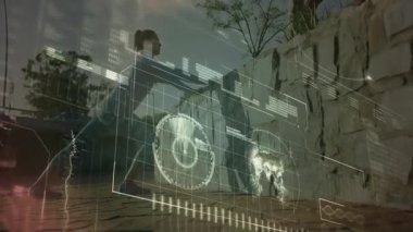 Kadın esnekliğini derinleştirirken, el kameraları ile duvarla temas kuruyor. Fitness, esneklik, açık hava, teknoloji, modern sağlık, egzersiz