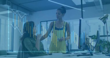 Discussing coworkers in yellow overalls at open-plan office with smartphone and barchart overlay. Collaboration, teamwork, modernworkplace, creativeindustry, technology, innovation, communication