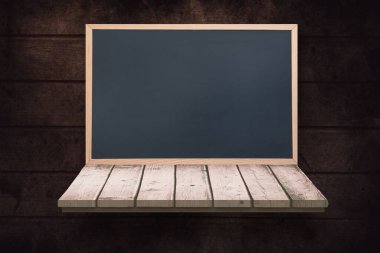 Blackboard on a wooden shelf