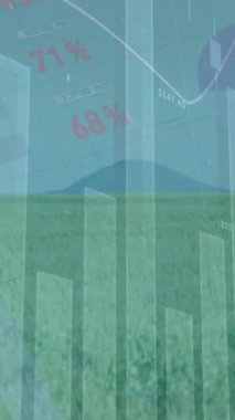 Animation of statistical data processing over spinning windmills on grassland against blue sky. Renewable energy and business technology concept