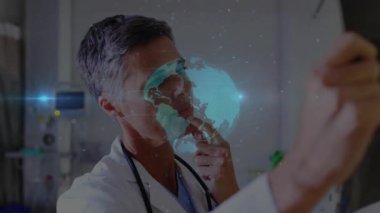 Doctor entering exam room with display, materializing rotating globe for medical diagnosis. Futuristic, technology, innovation, professionalism, healthcare, visualization, digital