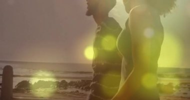 Günbatımında yürüyen bir çift, mercek alevi küreler ortaya çıkarken ve seyahat sahnesinde sürüklenirken. Romantizm, dinginlik, alacakaranlık, eğlence, ufuk, doğa, sükunet