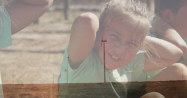 Açık yeşil gömlek ve erkek kardeşlerle arka bahçede şort giyen kız antrenman yapıyor, fitness yapıyor. Açık hava fitness, aile aktivitesi, doğal çevre, enerjik, aktif yaşam tarzı, günlük kıyafet, günbatımı aydınlatma