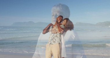 Sahilde kumlu sahilde kucaklaşan gülümseyen bir çift, okyanus dalgaları ve son sınıf anılarıyla. Romantizm, nostalji, dinginlik, yansıma, sahil, sükunet, manzara